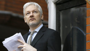 Wikileaks founder Julian Assange looks up as he speaks on the balcony of the Ecuadorean Embassy in London, Friday, Feb. 5, 2016. A U.N. human rights panel says WikiLeaks founder Julian Assange, who has been squirreled away inside the Ecuadorean Embassy in London to avoid questioning by Swedish authorities about sexual misconduct allegations, has been "arbitrarily detained" by Britain and Sweden since December 2010. The U.N. Working Group on Arbitrary Detention said his detention should end and he should be entitled to compensation. (AP Photo/Kirsty Wigglesworth)